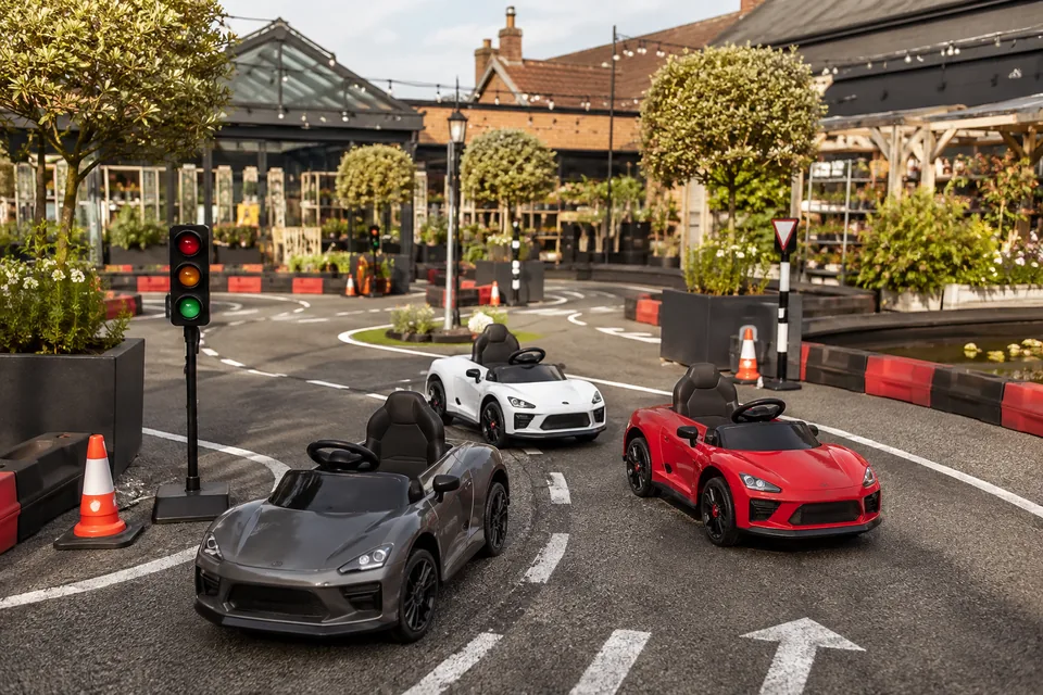 Illustrative placeholder: miniature cars on a purpose-built driving circuit